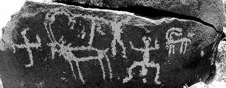 Rock art panel combining an egg, cross, ibex, and paired human figures